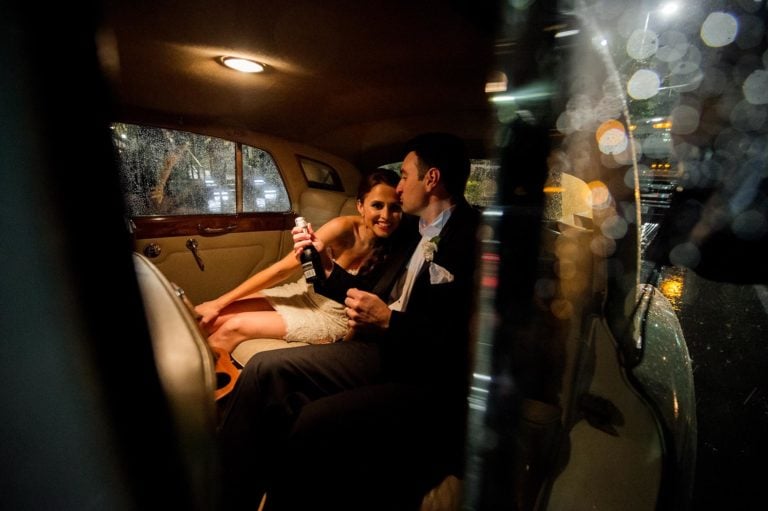 Couple depart in antique car The Julia Ideson Library