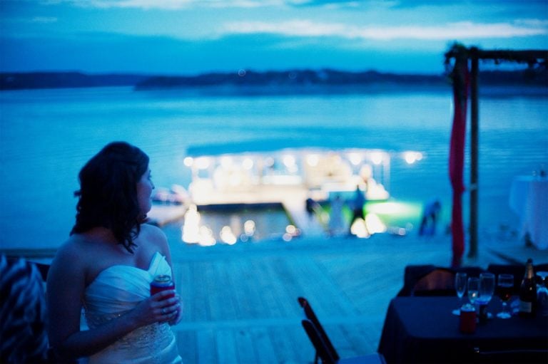 Bride at looks over her shoulder toward Medina Lake, San Antonio, Texas