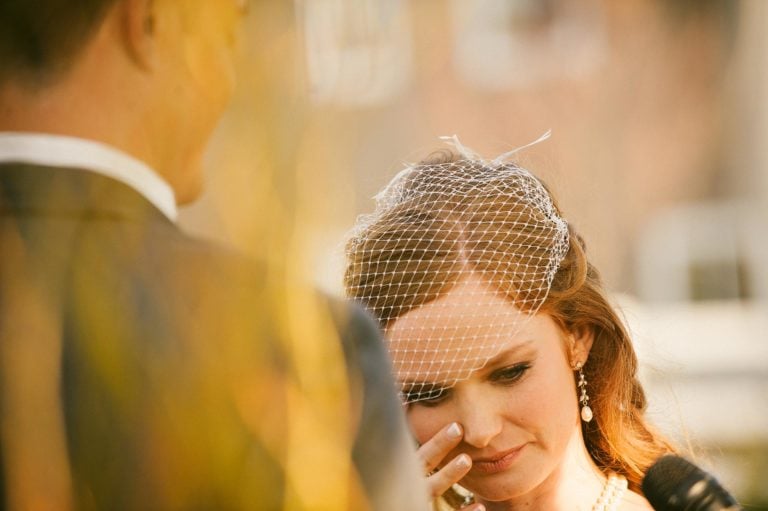 Bride wipes tear. Wedding at Crooked Willow Farms, Larkspur,CO