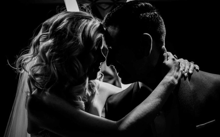 Couple just married with back light silhouette photographed at St. Anthony Hotel in San Antonio, Texas by destination Leica wedding photographer Philip Thomas