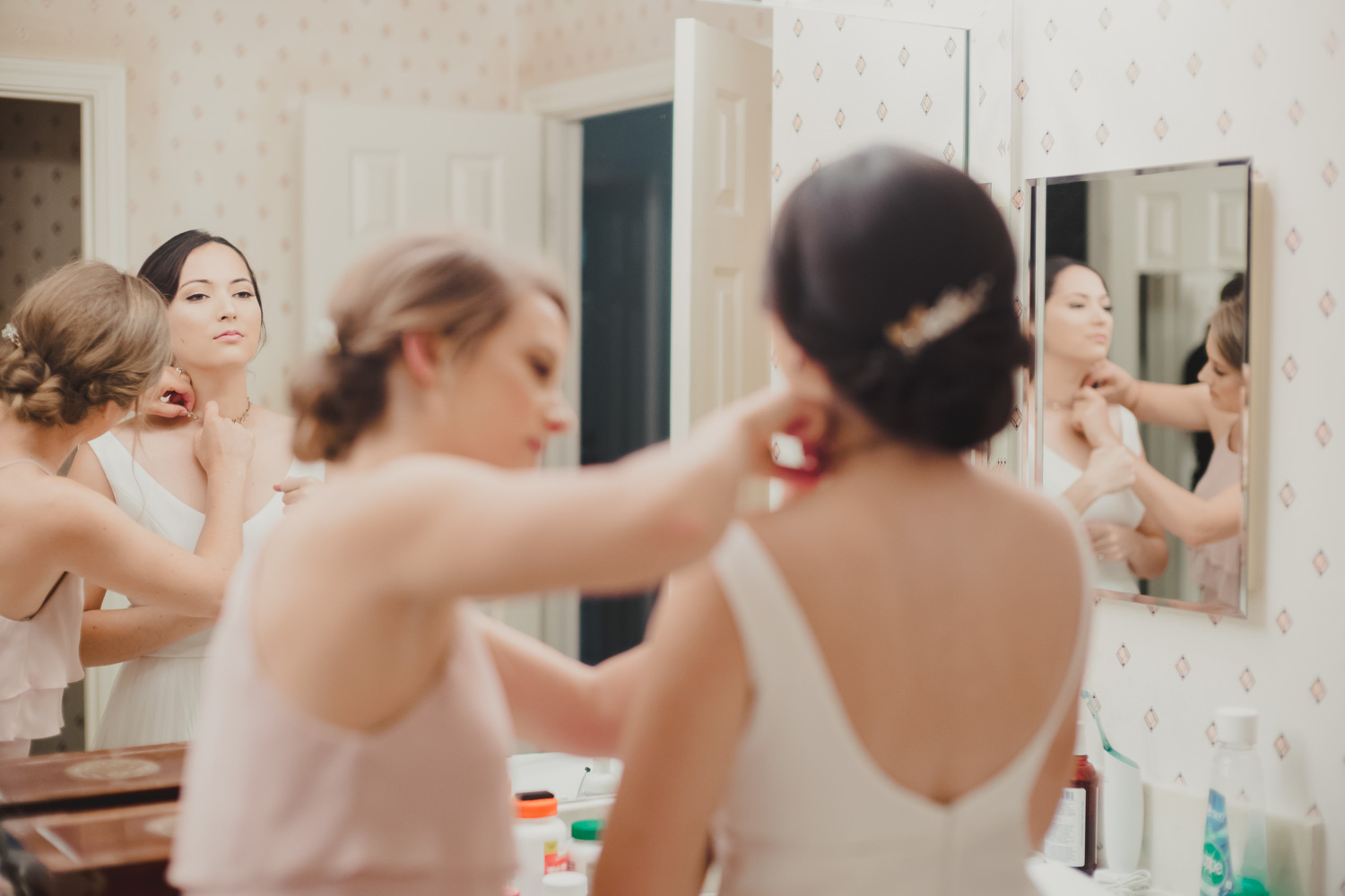 Bride checks the mirror after getting dressed at Cherie Flores Garden Pavilion Wedding Hermann Park Houston Texas-Philip Thomas