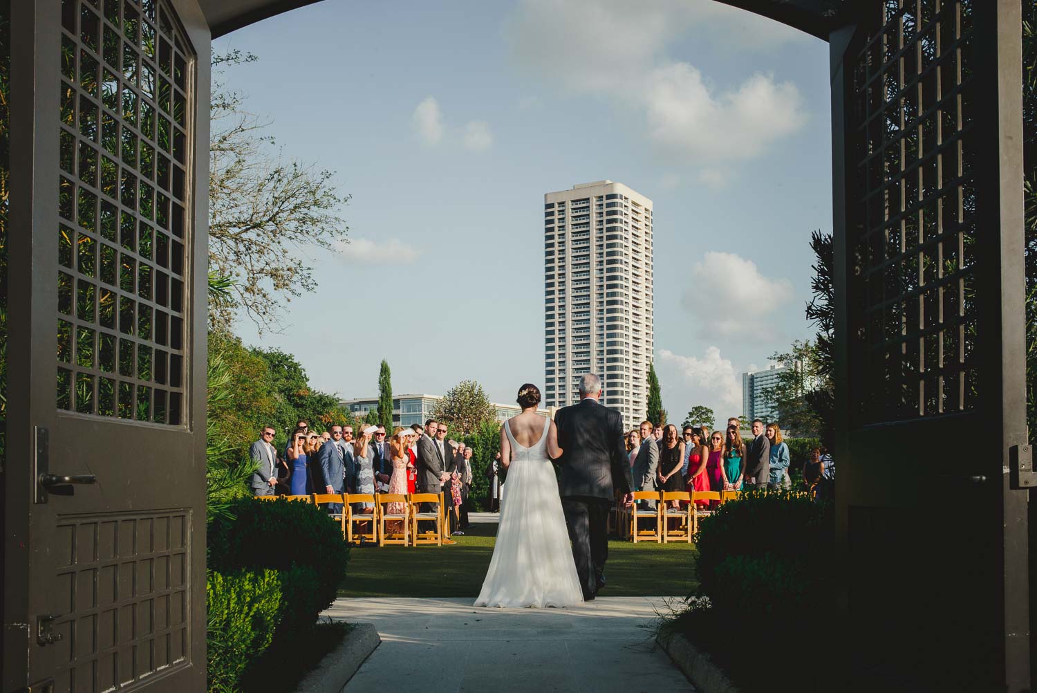 Bride and father walk down the aisle at Cherie Flores Garden Pavilion Wedding Hermann Park Houston Texas-Philip Thomas