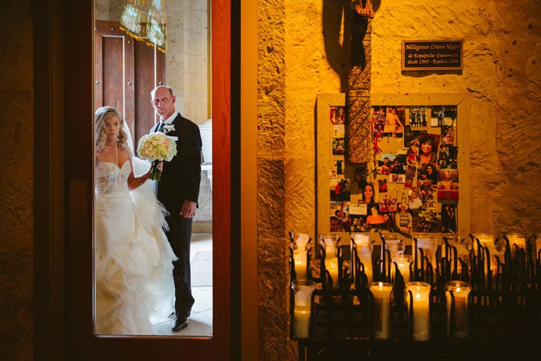 At San Fernando Cathedral Bride and father await the signal to proceed to the start of the walk down the aisle at San Fernando Cathedral in San Antonio, Texas photographed with a Leica M by Philip Thomas