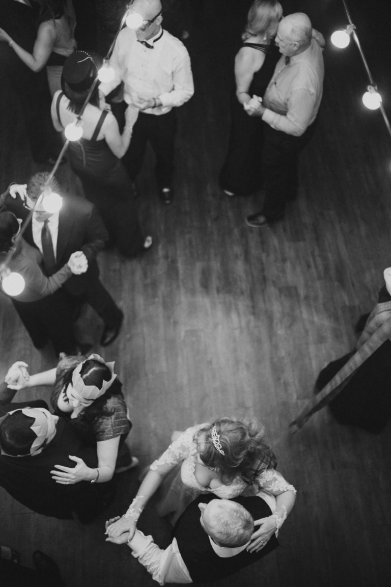 A wedded couple dance with friends under the lights of The Gallery Houston Wedding - Philip Thomas Photography-39