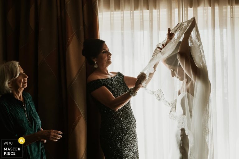 San Antonio wedding photographers Philip Thomas with Mother and grandmother of the bride assist bride with her veil at The Westin Riverwalk Hotel in San Antonio Texas - WPJA Award winning image San Antonio wedding photographer Philip Thomas