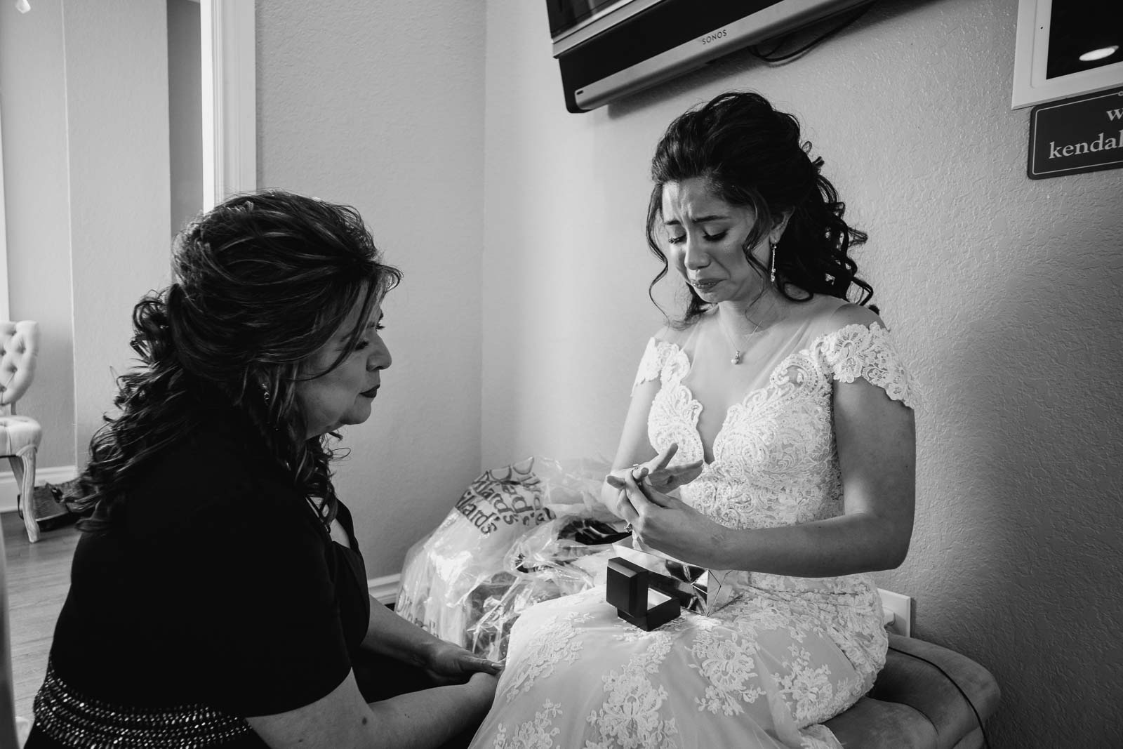 In a quiet moment before leaving the wedding venue the daughter tears up as she adds her grandmother’s ring