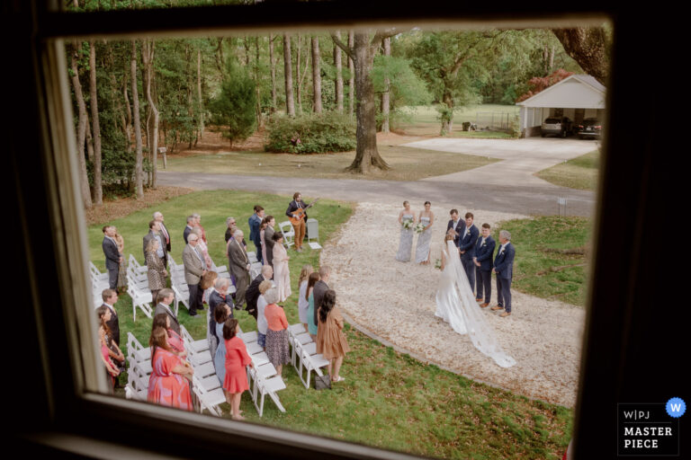 A home wedding for this lucky photographer in Georgia, South Carolina. Photographed through the window toward their ancient oak tree. L1008593 candid natural wedding image 2689655