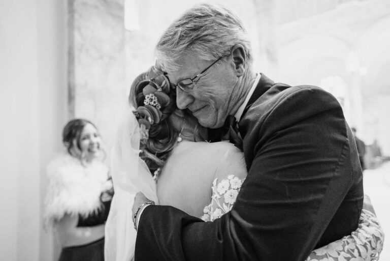 A father hugs his daughter at The Chapel of the Incarnate Word in San Antonio, Texas