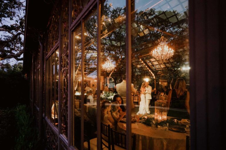 a group of people at a wedding reception photographed through window - Philip Thomas is a San Antonio wedding photographer L1000635b