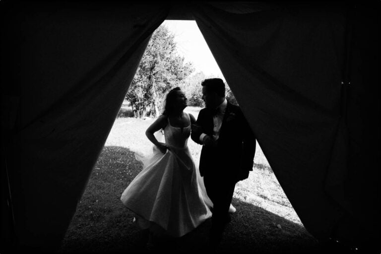 a man and woman in a wedding dress enter a holding area tent - 052 Kendalia Hill Country Wedding Ceremony + Reception Philip Thomas Photography