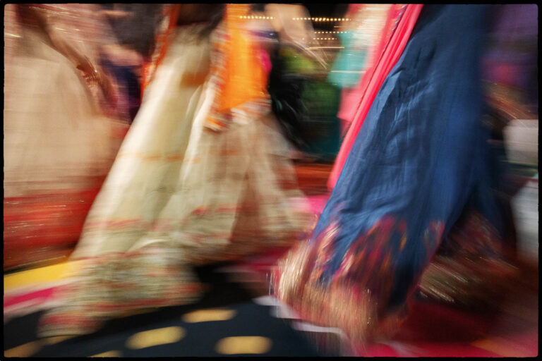 The camera shutter is opened for a long exposure during th evening sangeet showing a group of women in dresses -022 The Videre Estate South Asian Wedding in Wimberley Texas Philip Thomas wedding photographer L1070883 Edit