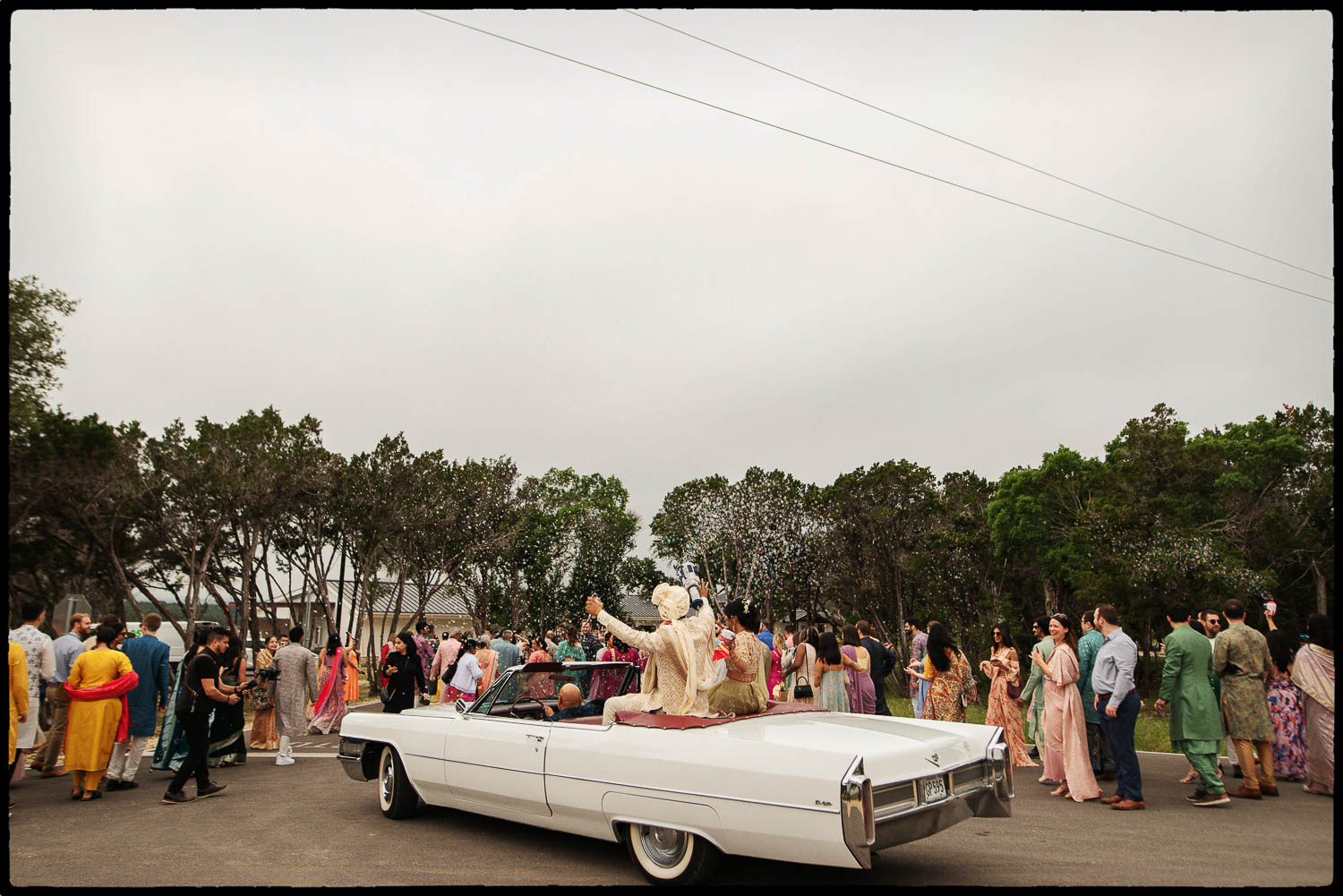 A wide angle of the baratt and the groom in a car