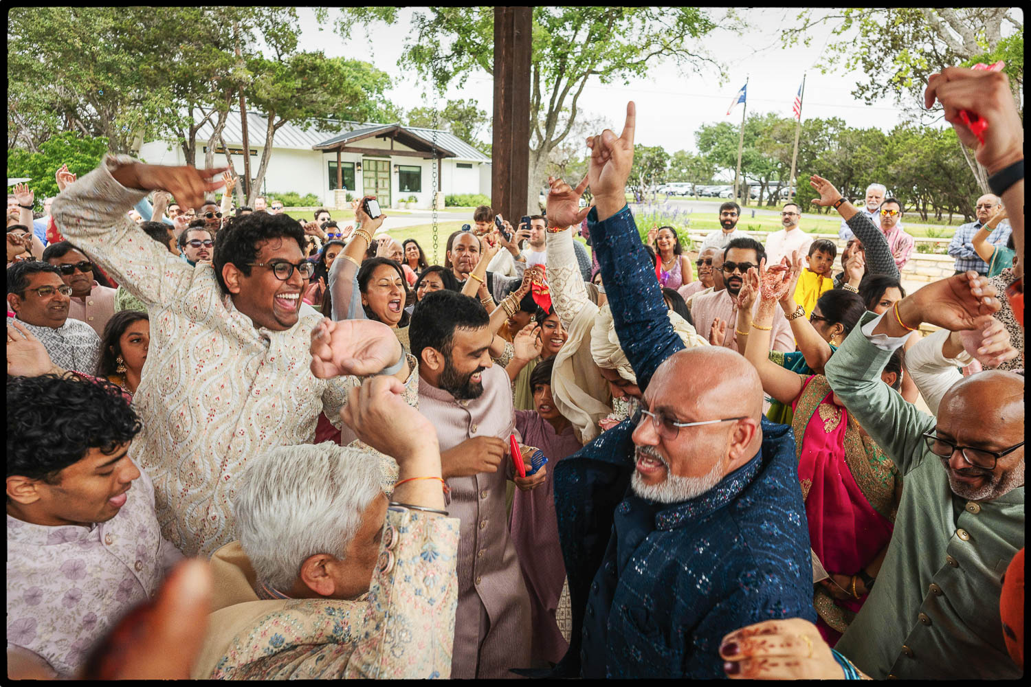a group of people celebrating during the Baraat is derived from Sanskrit word Varayātrā (वरयात्रा) literally meaning groom's procession