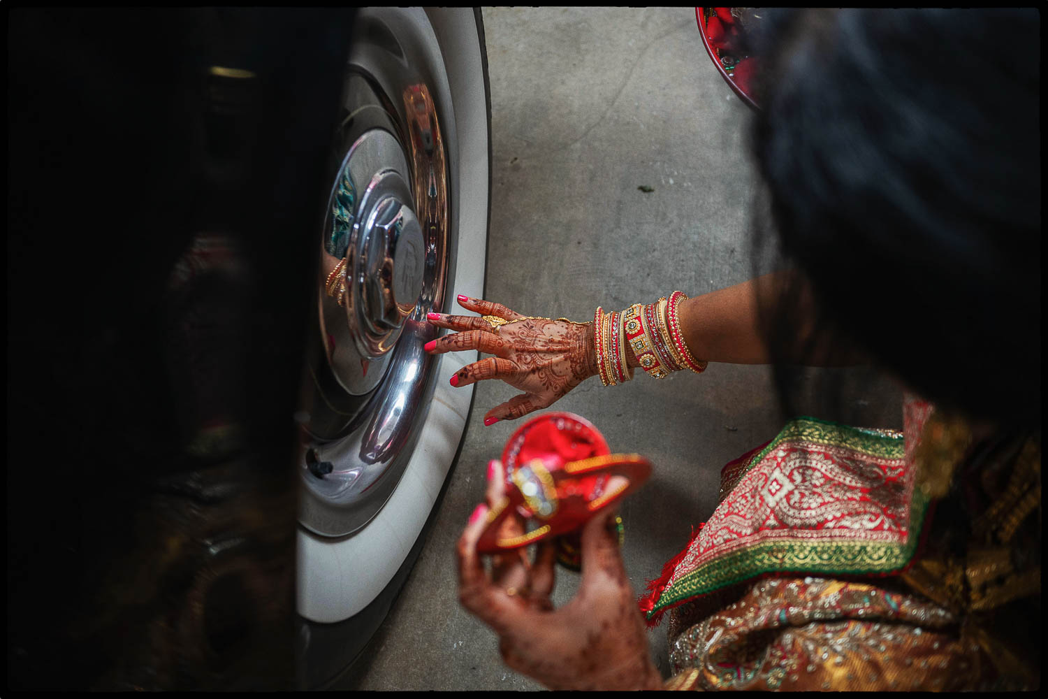 a woman with henna painted hands touching a wheel