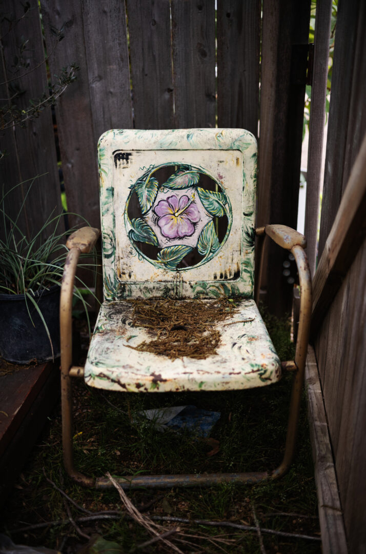 a chair with a flower painted on it L1007919 Edit