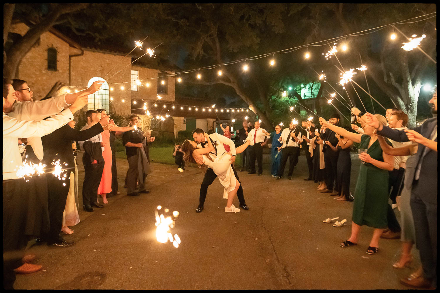 a man and woman kissing in front of a crowd of people Warner + Andrew Stunning Wedding at The Veranda in San Antonio, Texas Philip Thomas wedding photographer L1100646 Edit