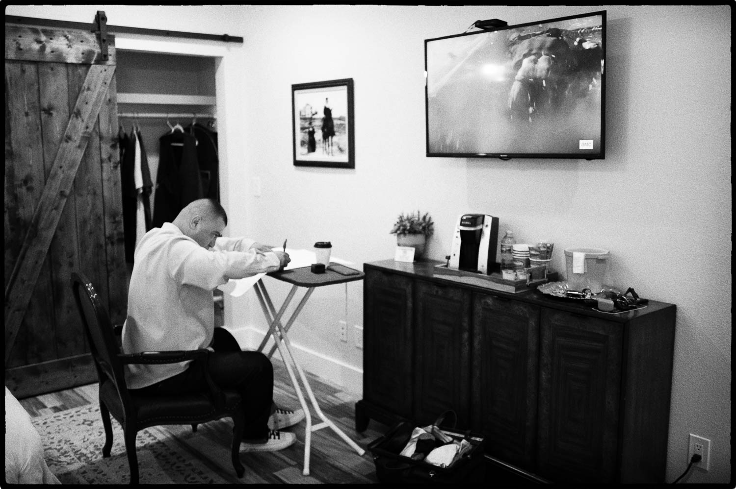 a man sitting at a desk WRITING HIS WEDDING VOWS